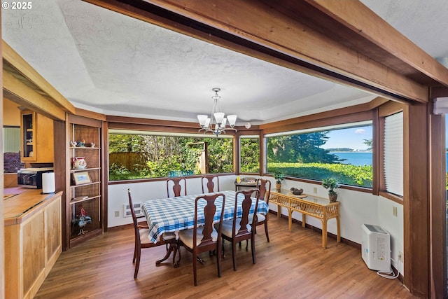 1230 Seagate Ave, Coos Bay, OR 97420 - dining room with a chandelier, wood finished floors, and a textured ceiling