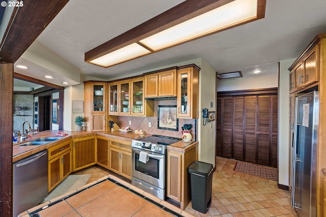1230 Seagate Ave, Coos Bay, OR 97420 - kitchen featuring stainless steel appliances, a sink, light tile patterned flooring, decorative backsplash, and recessed lighting