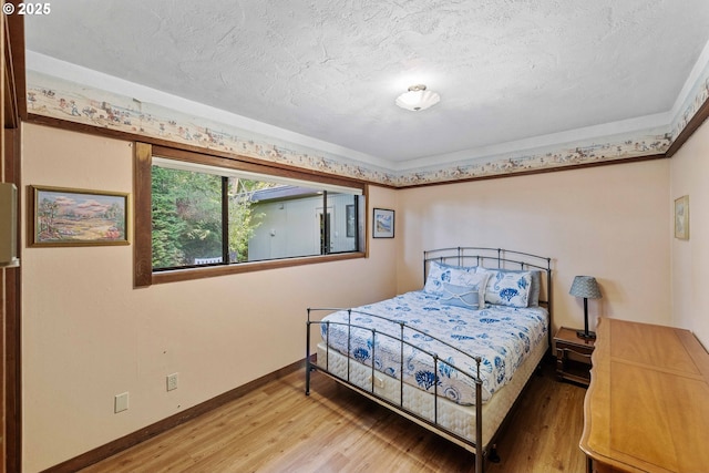 1230 Seagate Ave, Coos Bay, OR 97420 - bedroom featuring light wood-type flooring, baseboards, and a textured ceiling