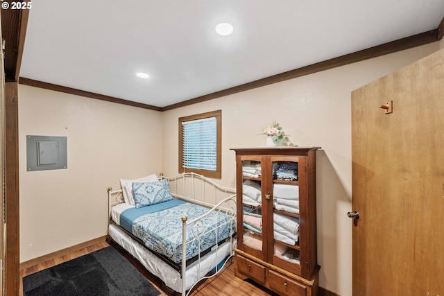 1230 Seagate Ave, Coos Bay, OR 97420 - bedroom featuring wood finished floors, electric panel, ornamental molding, recessed lighting, and baseboards