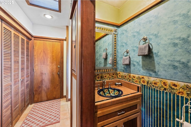 1230 Seagate Ave, Coos Bay, OR 97420 - bathroom featuring vanity, wallpapered walls, tile patterned flooring, and a closet