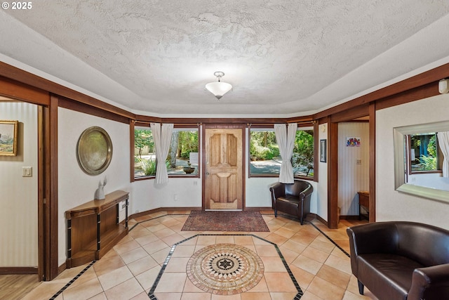 1230 Seagate Ave, Coos Bay, OR 97420 - foyer entrance with healthy amount of natural light, baseboards, light tile patterned floors, and a textured ceiling