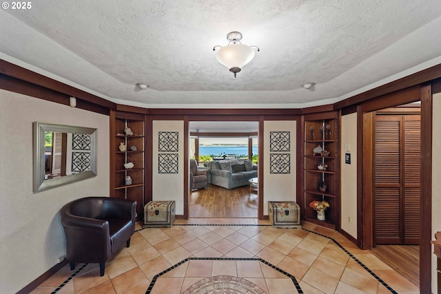 1230 Seagate Ave, Coos Bay, OR 97420 - entryway featuring inlaid floor details, a textured ceiling, baseboards, and light tile patterned floors