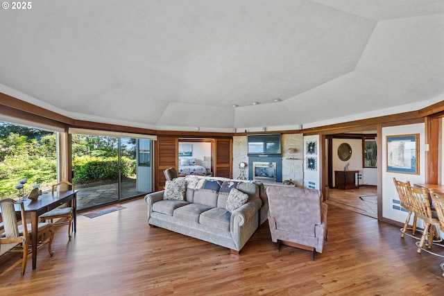 1230 Seagate Ave, Coos Bay, OR 97420 - living room featuring a tray ceiling, vaulted ceiling, and light wood-style floors