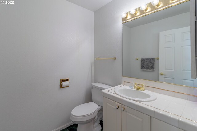 416 Elmar Dr, Winchester, OR 97495 - bathroom featuring vanity, toilet, and baseboards