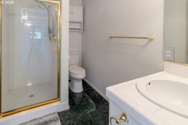 416 Elmar Dr, Winchester, OR 97495 - bathroom featuring a stall shower, toilet, vanity, and baseboards