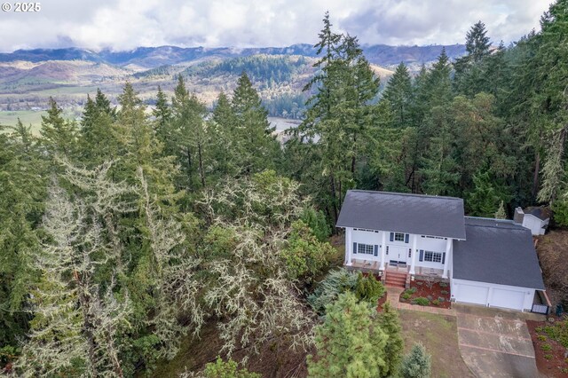 416 Elmar Dr, Winchester, OR 97495 - aerial view of property and surrounding area featuring a heavily wooded area and a mountain backdrop