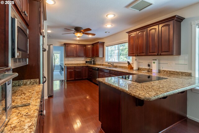 416 Elmar Dr, Winchester, OR 97495 - kitchen with stainless steel appliances, a peninsula, ceiling fan, tasteful backsplash, and a breakfast bar