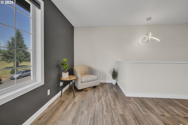 4634 Harriet Ave, Eugene, OR 97402 - sitting room featuring healthy amount of natural light, a chandelier, and wood finished floors