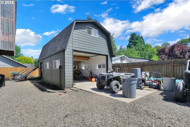 4634 Harriet Ave, Eugene, OR 97402 - view of home's exterior with a gambrel roof, a shingled roof, a garage, and an outdoor structure