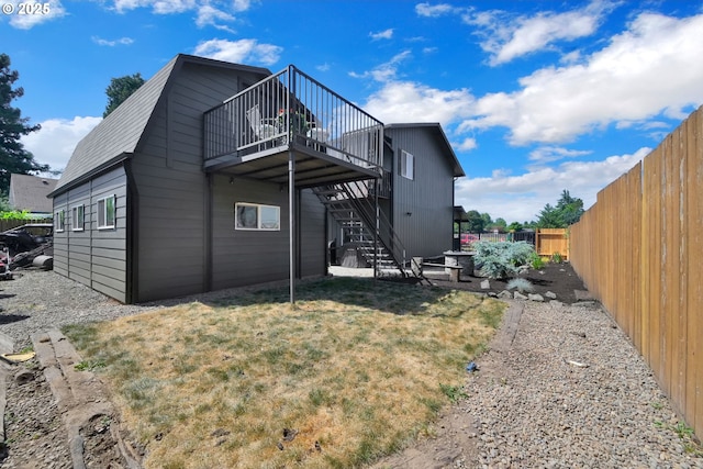 4634 Harriet Ave, Eugene, OR 97402 - back of property featuring stairway, a fenced backyard, a gambrel roof, and a wooden deck