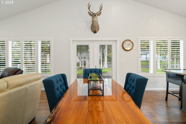 dining area with vaulted ceiling, hardwood / wood-style floors, and baseboards