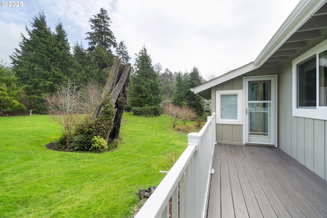 wooden terrace with a lawn