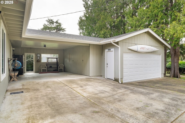 garage with an attached carport and visible vents