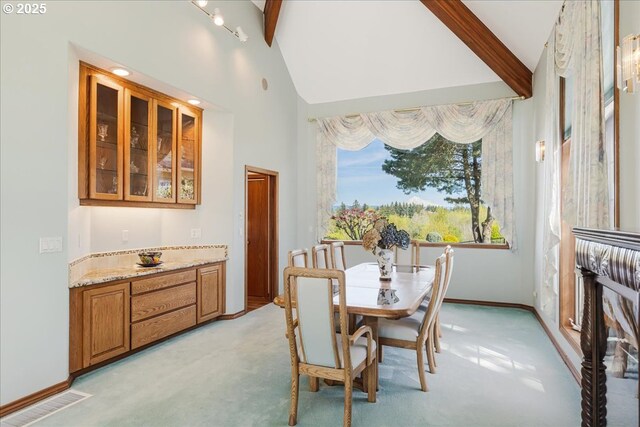 300 SE Arrow Creek Ln, Gresham, OR 97080 - dining area with beamed ceiling, light colored carpet, baseboards, and high vaulted ceiling