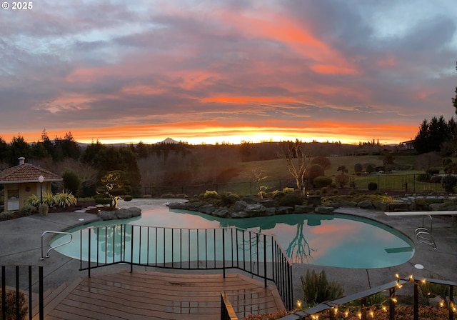 300 SE Arrow Creek Ln, Gresham, OR 97080 - pool at dusk with a patio area and fence