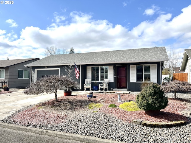 single story home featuring a shingled roof, covered porch, fence, a garage, and driveway