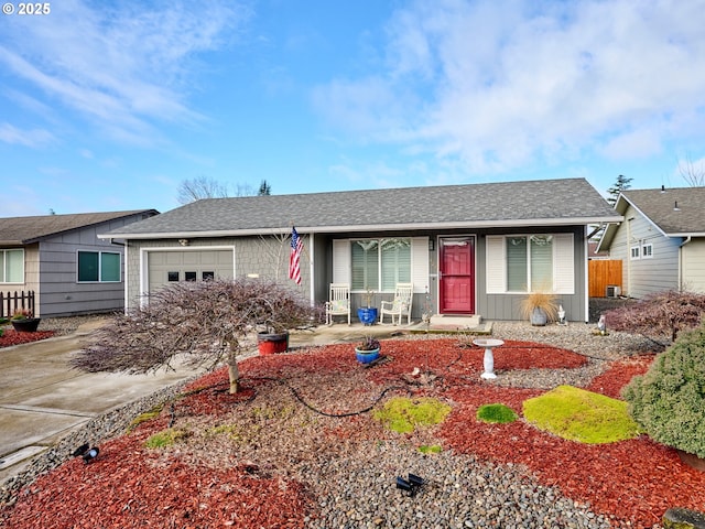 427 E Clackamas Cir, Woodburn, OR 97071 - ranch-style house featuring an attached garage, fence, driveway, and a shingled roof