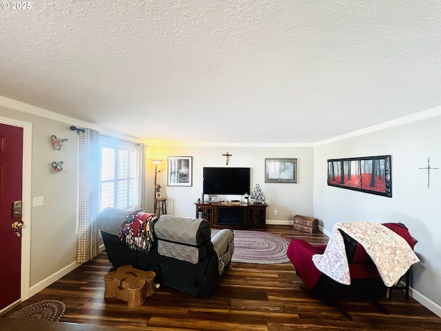 living area featuring a textured ceiling, baseboards, and wood finished floors