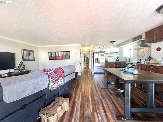 living area with a textured ceiling and dark wood-type flooring