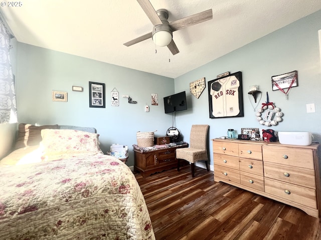 bedroom with ceiling fan, a textured ceiling, and dark wood-style flooring