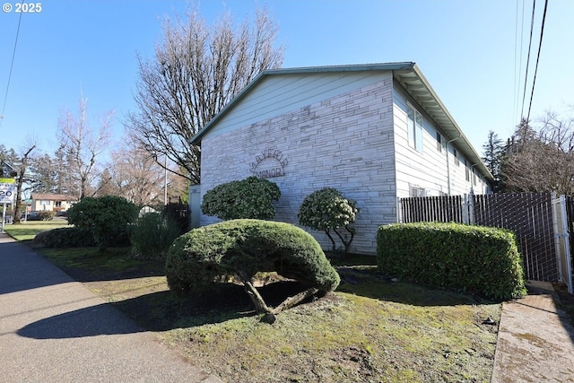 view of side of property featuring fence