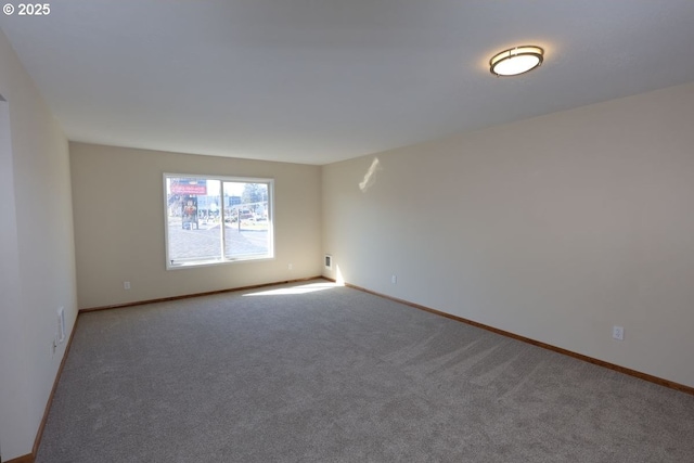 empty room with carpet floors and baseboards