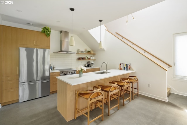 4889 NE Going St, Portland, OR 97218 - kitchen featuring appliances with stainless steel finishes, wall chimney range hood, a peninsula, a kitchen bar, and backsplash