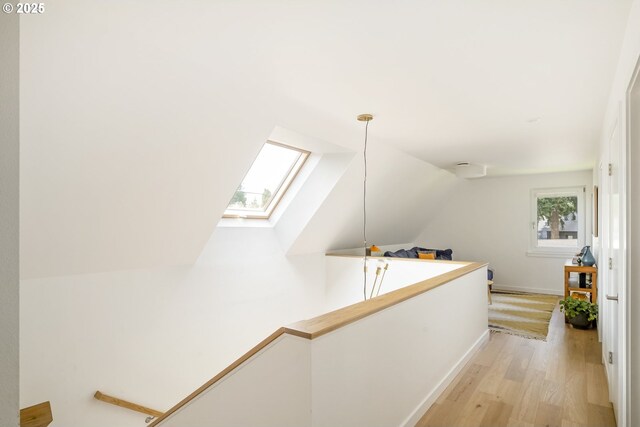 4889 NE Going St, Portland, OR 97218 - corridor featuring a skylight, light wood-style flooring, an upstairs landing, and lofted ceiling