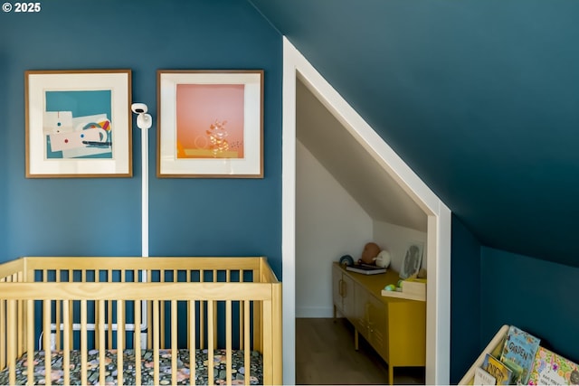 4889 NE Going St, Portland, OR 97218 - bedroom featuring a crib, vaulted ceiling, and wood finished floors