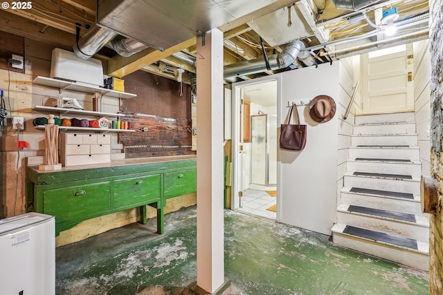 unfinished basement with a workshop area and stairway