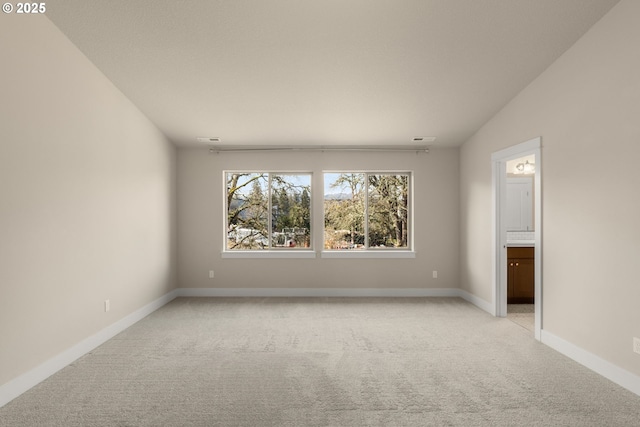 unfurnished room with light colored carpet, visible vents, and baseboards