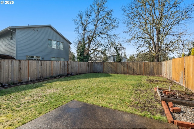 view of yard with a garden and a fenced backyard