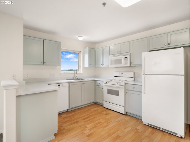 15325 NW Central Dr Unit 301, Portland, OR 97229 - kitchen with white appliances, light wood finished floors, light countertops, and gray cabinetry