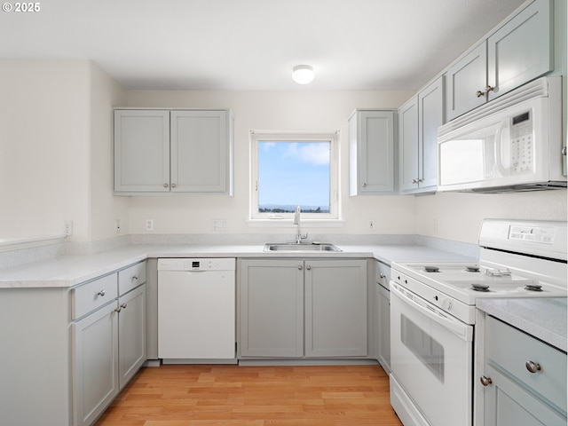 15325 NW Central Dr Unit 301, Portland, OR 97229 - kitchen featuring white appliances, light wood-type flooring, and light countertops