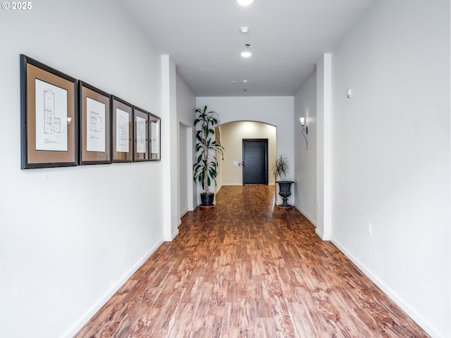 15325 NW Central Dr Unit 301, Portland, OR 97229 - corridor with arched walkways, wood finished floors, and recessed lighting