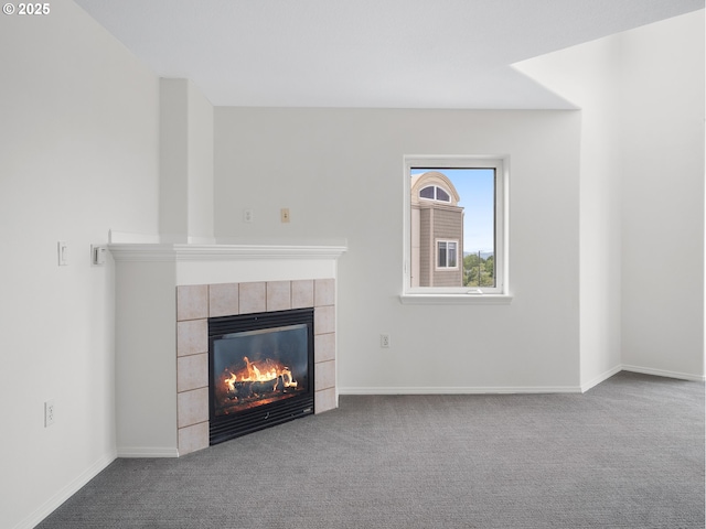 15325 NW Central Dr Unit 301, Portland, OR 97229 - unfurnished living room featuring a tiled fireplace and carpet