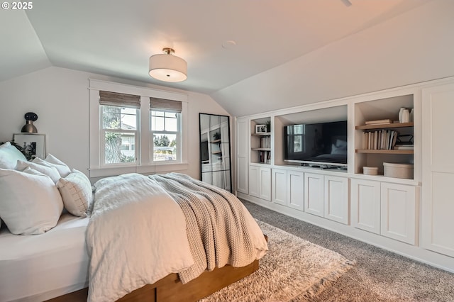 bedroom with lofted ceiling and carpet