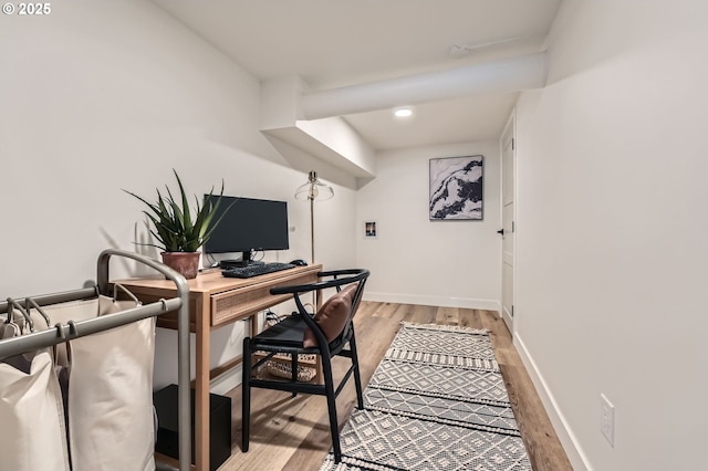 office area with light wood-type flooring and baseboards