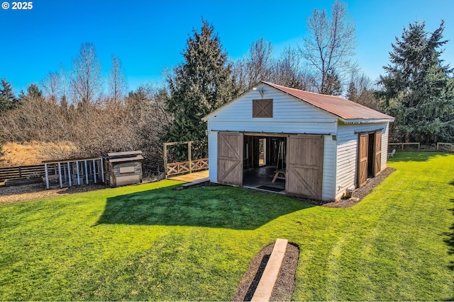 view of outbuilding with an outbuilding and fence