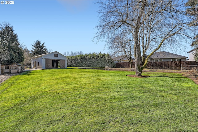 view of yard with an outbuilding, a pole building, and fence