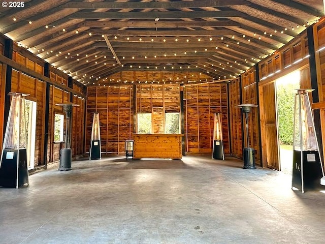 interior space with concrete flooring and lofted ceiling