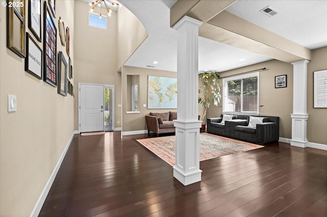 21615 SW Derby Ter, Sherwood, OR 97140 - foyer entrance featuring decorative columns, dark wood-style flooring, and baseboards