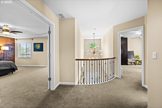21615 SW Derby Ter, Sherwood, OR 97140 - hallway featuring carpet floors, a chandelier, and baseboards