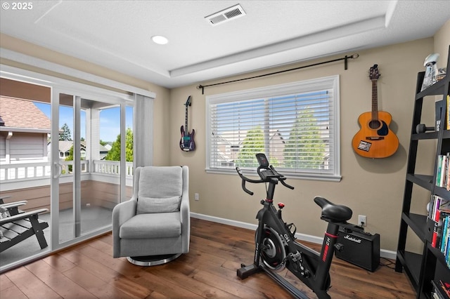 21615 SW Derby Ter, Sherwood, OR 97140 - exercise room with a raised ceiling, plenty of natural light, hardwood / wood-style flooring, and recessed lighting