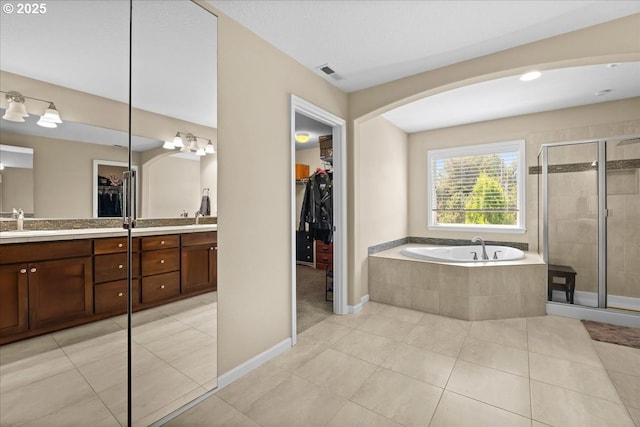 21615 SW Derby Ter, Sherwood, OR 97140 - full bathroom featuring a spacious closet, double vanity, a garden tub, a shower stall, and tile patterned floors