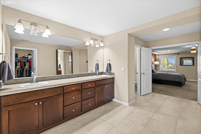 21615 SW Derby Ter, Sherwood, OR 97140 - ensuite bathroom with double vanity, toilet, baseboards, and a spacious closet