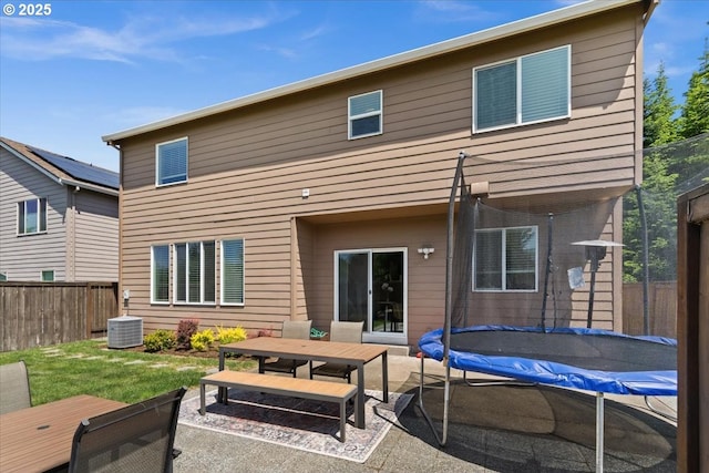 21615 SW Derby Ter, Sherwood, OR 97140 - back of property featuring outdoor dining space, a trampoline, a patio, and central air condition unit