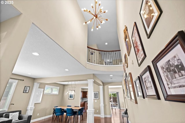 21615 SW Derby Ter, Sherwood, OR 97140 - entrance foyer with ornate columns, a chandelier, a towering ceiling, baseboards, and recessed lighting