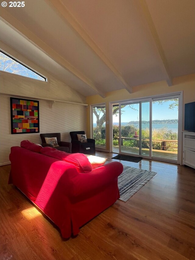 living room with wood finished floors and lofted ceiling with beams